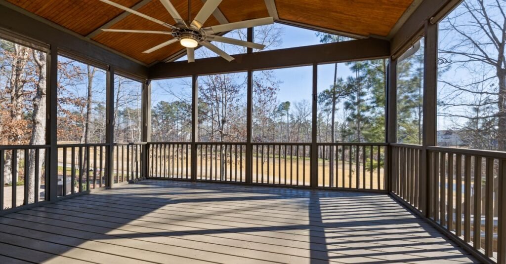 Wooden porch ceiling with a large fan