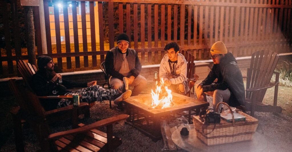 Friends gathered around a fire table at night