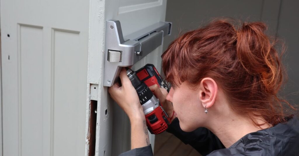 Woman installing hardware on a white door